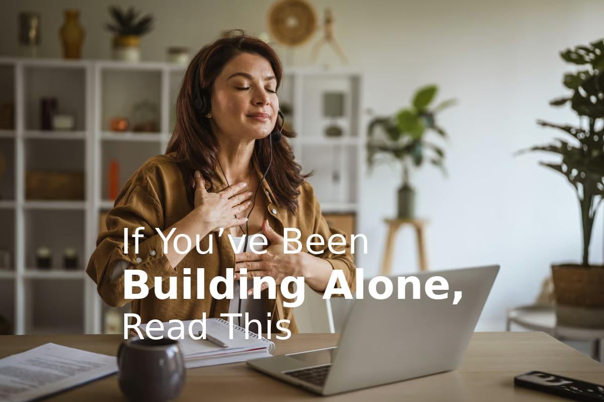 Woman at desk with laptop in home office, text overlay reads If Youve Been Building Alone, Read This